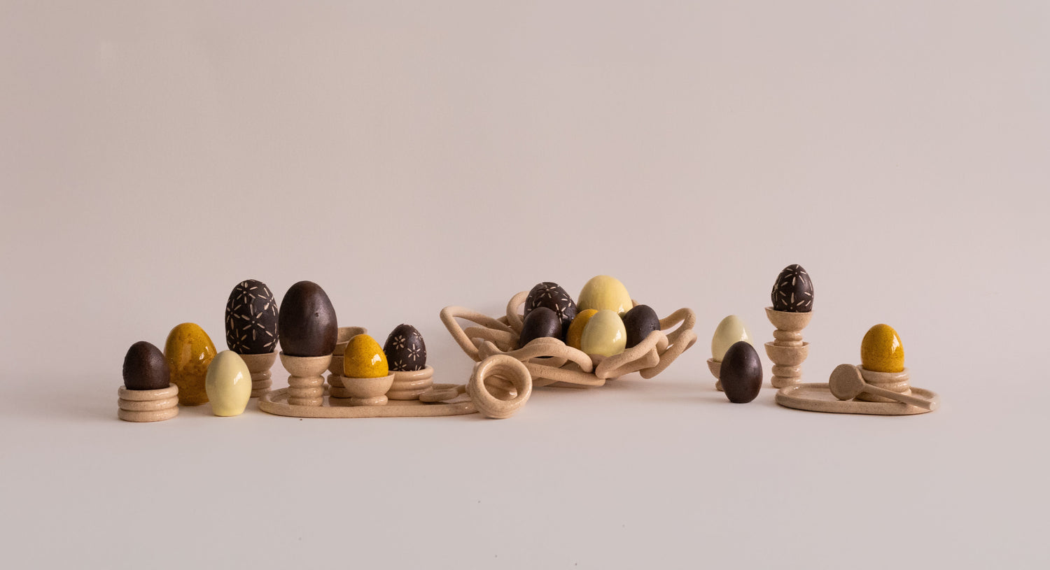 Handmade ceramic Easter tableware collection with egg cups, bowls and plates