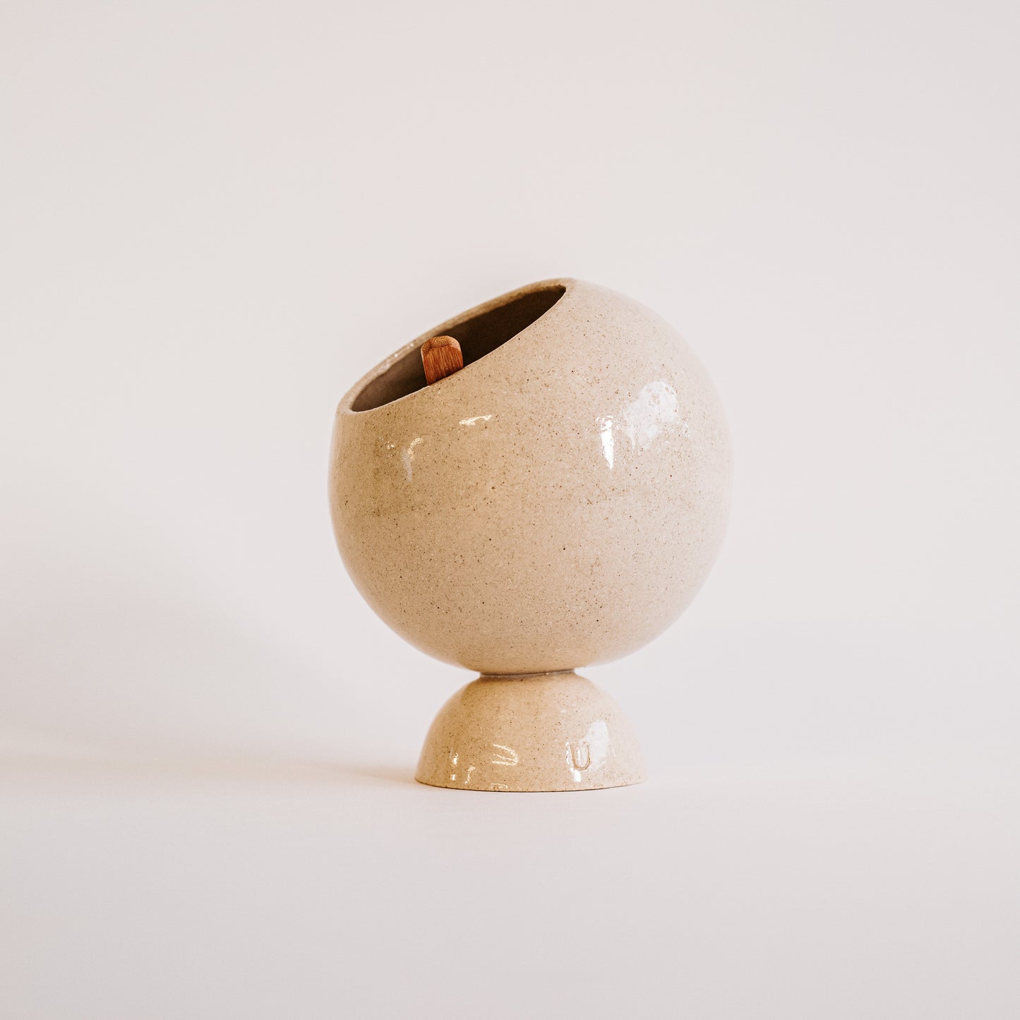 White ceramic salt cellar on a light beige background